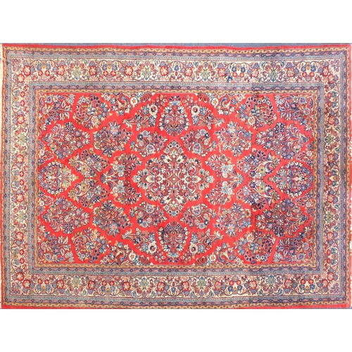 2015 - Rectangular Persian Sarough rug having an all over floral design onto a red ground, 300cm x 265cm