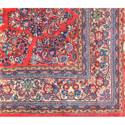 2015 - Rectangular Persian Sarough rug having an all over floral design onto a red ground, 300cm x 265cm
