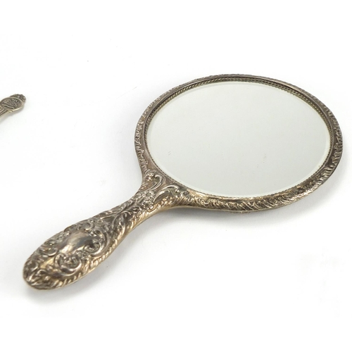 575 - Silver backed hand mirror, teaspoons and sugar tongs, some with enamelled terminals