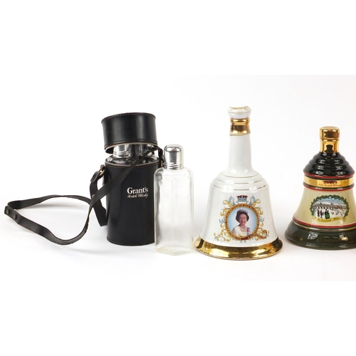 439 - Four Wade Bells whisky decanters, one with contents and a Grants three section decanter