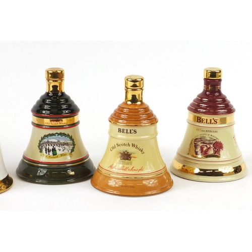 439 - Four Wade Bells whisky decanters, one with contents and a Grants three section decanter