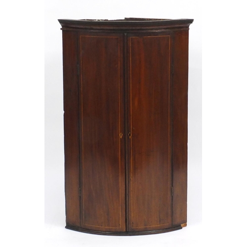 45 - Edwardian inlaid mahogany bow front corner cupboard, fitted with two shelves, 98cm H x 61cm W x 43cm... 