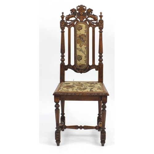 2 - Oak occasional chair carved with a lion crest and needlepoint upholstery, 113cm high