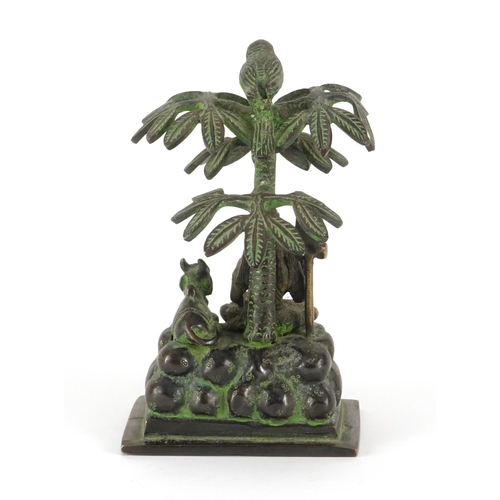 226 - Middle Eastern patinated bronze study of a deity under a tree, 17cm high