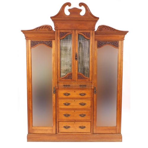 2063 - Satin walnut compactum wardrobe, with swan neck pediment above a pair of glazed doors over five draw... 