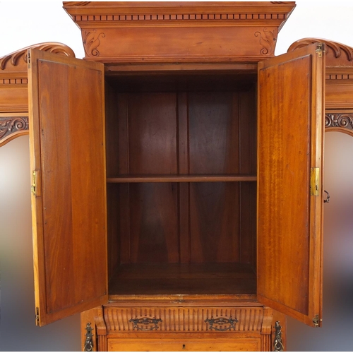 2063 - Satin walnut compactum wardrobe, with swan neck pediment above a pair of glazed doors over five draw... 