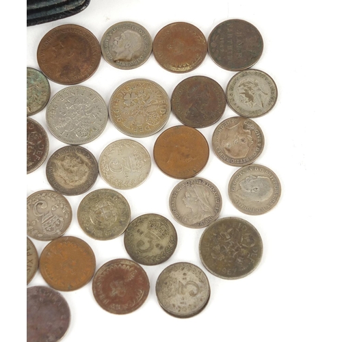 634 - Mostly British pre 1947 coins including silver three penny bits and six pence's, with a leather coin... 