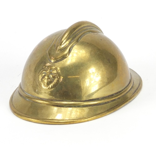 903 - Brass model of a fireman's helmet, inscribed Baudon, 12cm in length