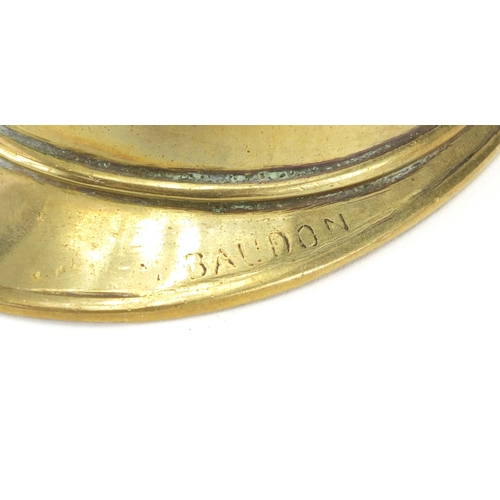 903 - Brass model of a fireman's helmet, inscribed Baudon, 12cm in length