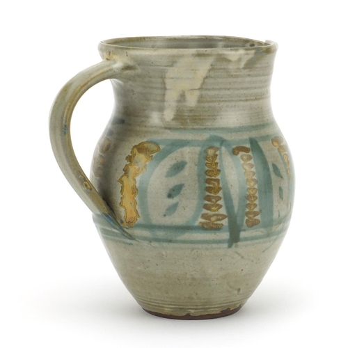 777 - Michael Cardew studio pottery jug hand painted with stylised motifs, impressed marks, 16cm high