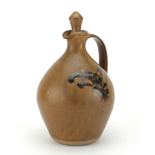 781 - Studio pottery flagon and stopper in the style of Bernard Leach, having a butterscotch glaze with st... 