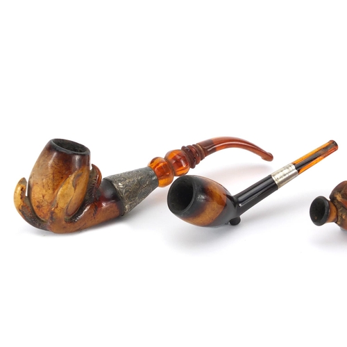 71 - Three Meerschaum style pipes including an example with a reclining female, each with fitted leather ... 