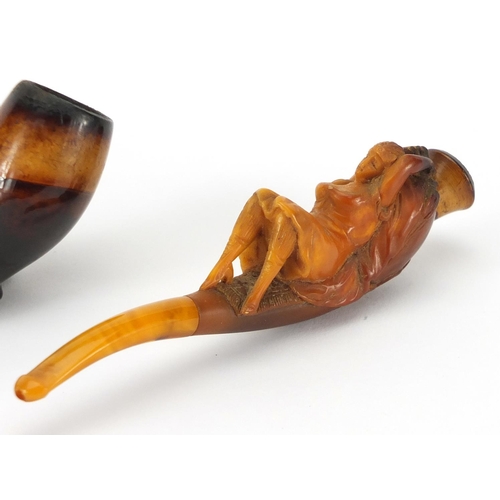 71 - Three Meerschaum style pipes including an example with a reclining female, each with fitted leather ... 