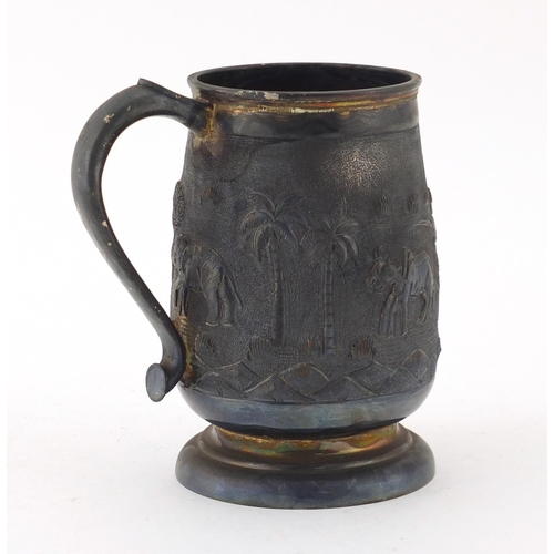 854 - Indian unmarked silver tankard embossed with a farmer and cattle, 13cm high, approximate weight 347.... 