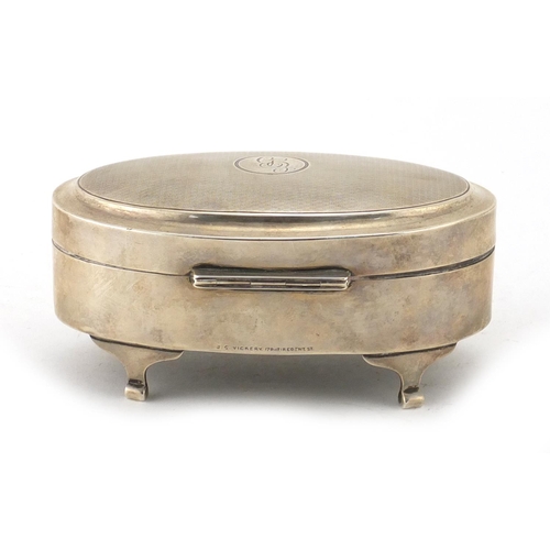 852 - Oval silver jewel box raised on four feet, the hinged lid with engine turned decoration, retailed by... 