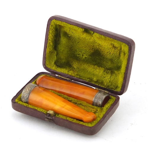 68 - Two butterscotch amber cheroots with silver mounts, housed in a fitted tooled leather box, Singleton... 