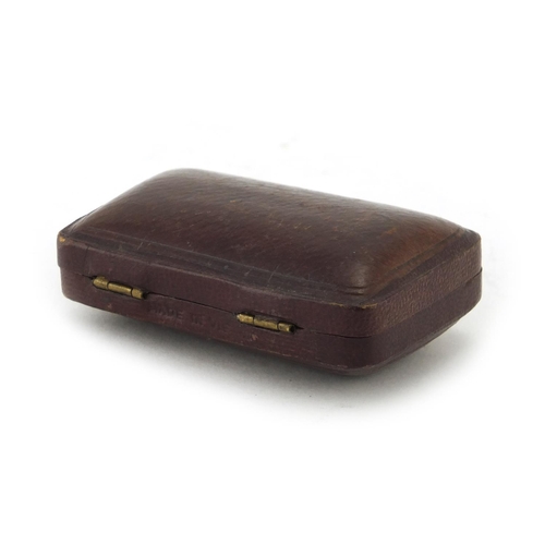 68 - Two butterscotch amber cheroots with silver mounts, housed in a fitted tooled leather box, Singleton... 