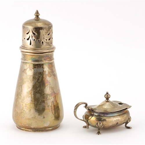 883 - Large silver caster and a mustard with blue glass liner, the caster London 1933, 16.5cm high, approx... 