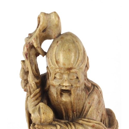 560 - Chinese russet and red soapstone carving of an elder holding a staff with a goat, 22cm high