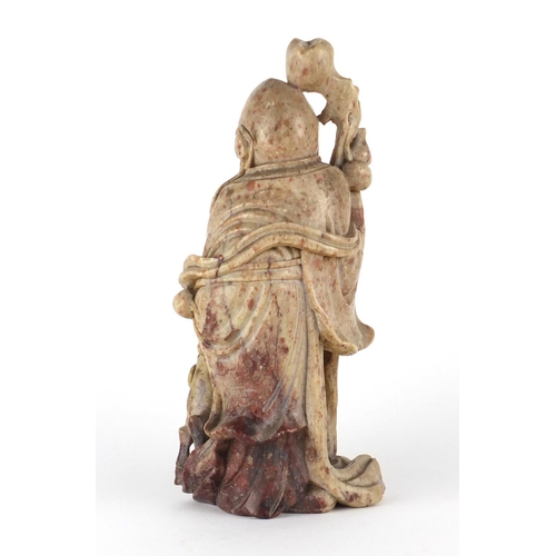 560 - Chinese russet and red soapstone carving of an elder holding a staff with a goat, 22cm high