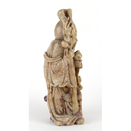 560 - Chinese russet and red soapstone carving of an elder holding a staff with a goat, 22cm high