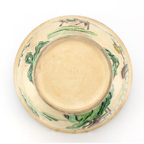 408 - Chinese famille verte pottery bowl, decorated in low relief with figures in a palace setting, six fi... 