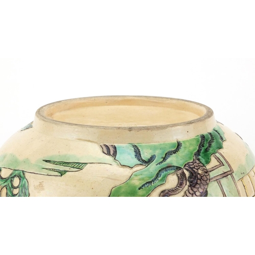 408 - Chinese famille verte pottery bowl, decorated in low relief with figures in a palace setting, six fi... 