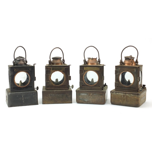 87 - Four Welch patent railway lamps, three with ceramic burners, each with various plaques including a F... 