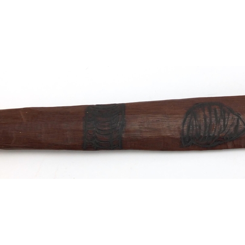 660 - Australian Aboriginal Churinga carved with tribal motifs, 58cm in length