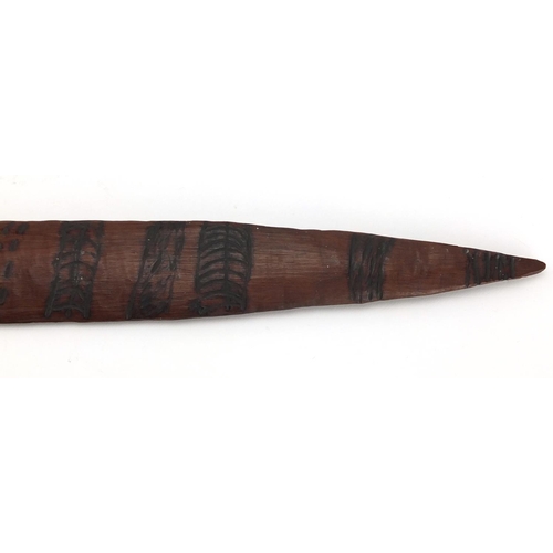 660 - Australian Aboriginal Churinga carved with tribal motifs, 58cm in length