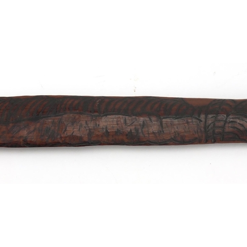 660 - Australian Aboriginal Churinga carved with tribal motifs, 58cm in length