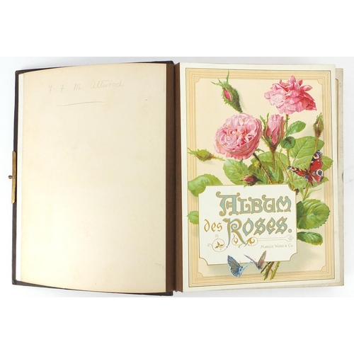 857 - Victorian leather bound photograph album, the pages decorated with roses, 30cm high