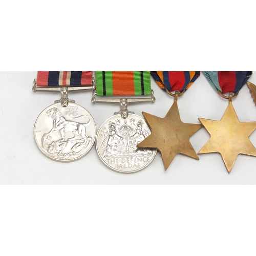 890 - Four British Military World War II medals and a Who Dares Wins badge