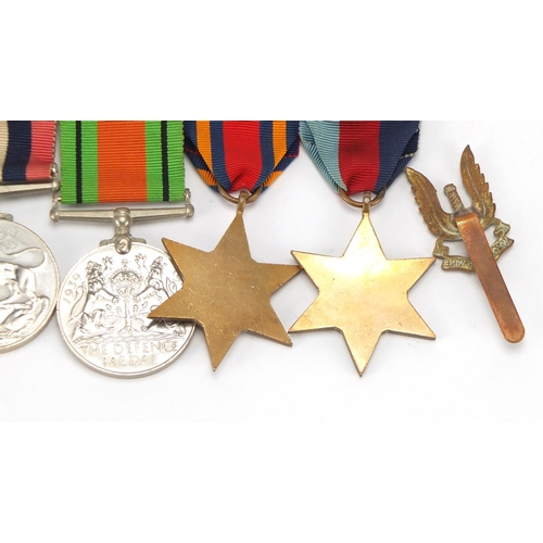 890 - Four British Military World War II medals and a Who Dares Wins badge