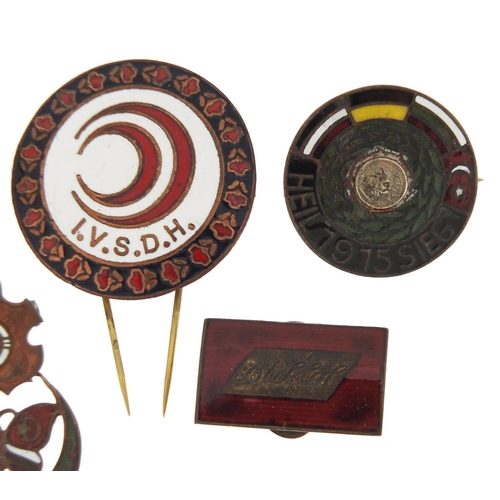 635 - Five Turkish enamelled badges, the largest 3.5cm in diameter