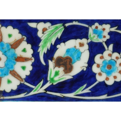 612 - Rectangular Iznik pottery tile, hand painted with flowers, 25cm x 13cm