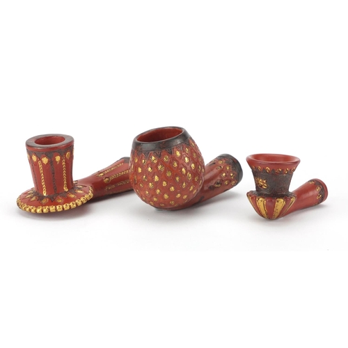 617 - Three Turkish Tophane terracotta pipe bowls with gilt deocration, the largest 10.5cm in length