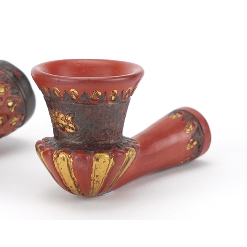 617 - Three Turkish Tophane terracotta pipe bowls with gilt deocration, the largest 10.5cm in length