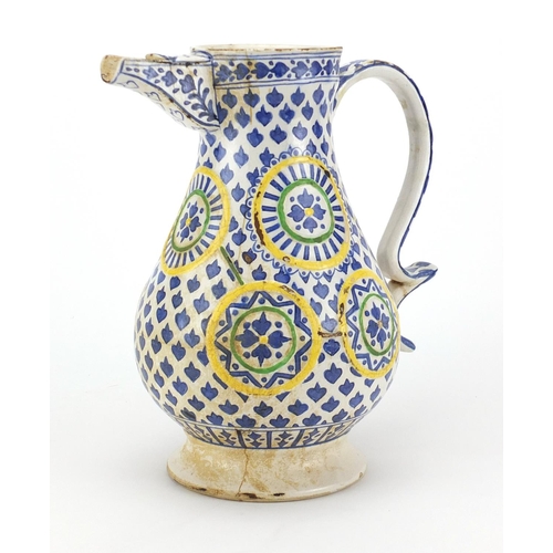 615 - 19th century Turkish Kutahya pottery water jug, hand painted with flower heads, 25.5cm high