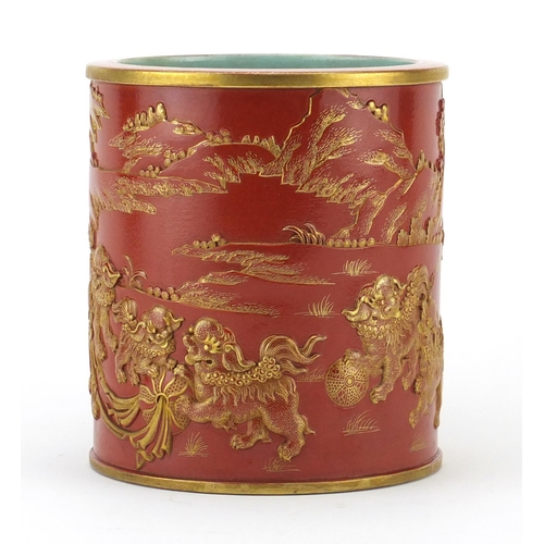 443 - Chinese porcelain iron red brush pot, decorated in relief and gilded with qilins in a landscape, fou... 