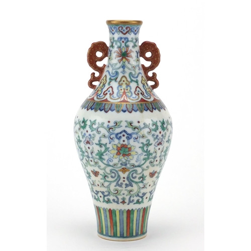 384 - Chinese porcelain doucai vase with iron red handles, finely hand painted with flower heads amongst f... 