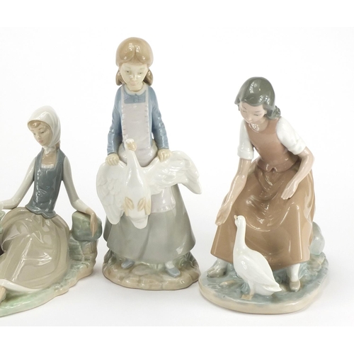 2575 - Lladro and Nao figures and animals including a young girl holding a goose, the largest 24.5cm high