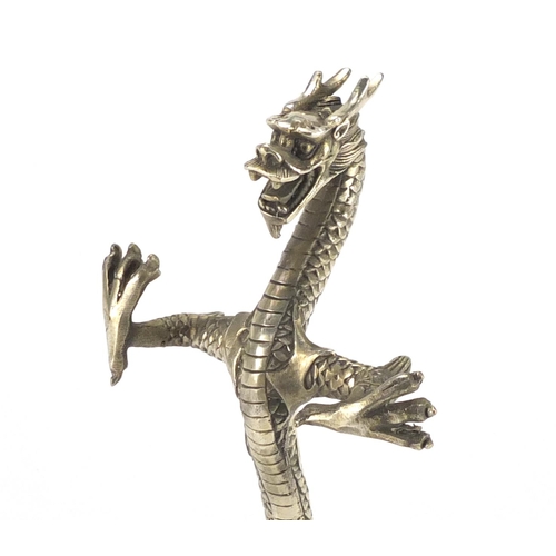 632 - Chinese silver coloured metal dragon, 21cm high
