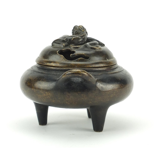 564 - Chinese patinated bronze tripod incense burner and cover with twin handles, character marks to the b... 