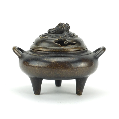 564 - Chinese patinated bronze tripod incense burner and cover with twin handles, character marks to the b... 