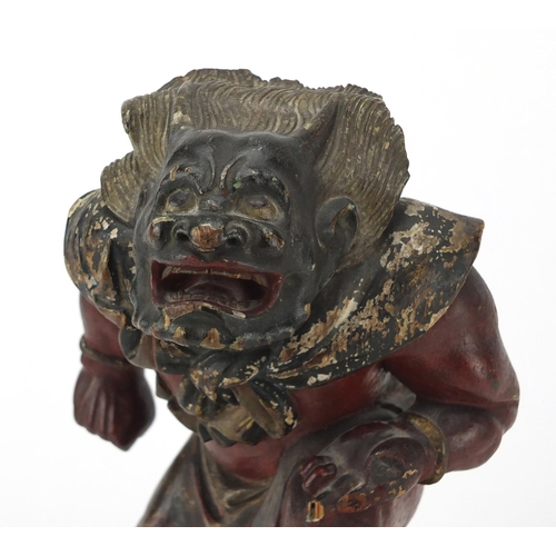 585 - Chinese lacquered wood carving of a warrior, 25.5cm high