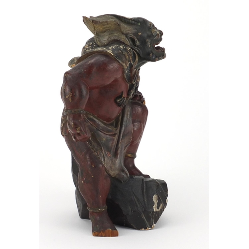 585 - Chinese lacquered wood carving of a warrior, 25.5cm high