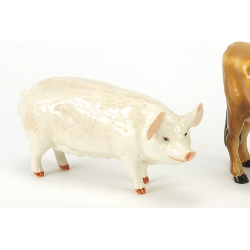 2563 - Two Beswick Champion pigs and a Champion Coy Boy Jersey Cow, the largest 11cm high