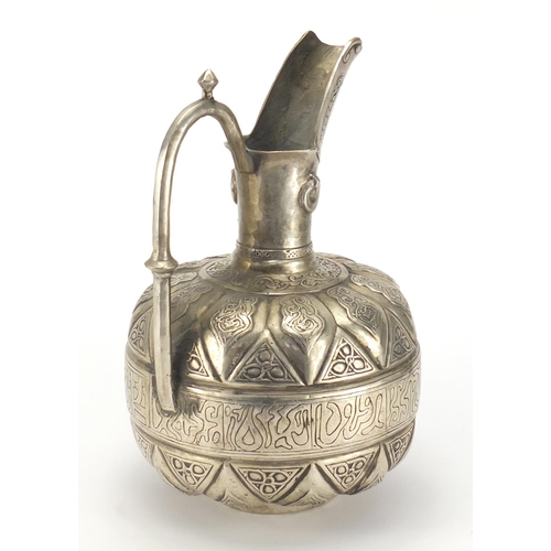 630 - Islamic silver coloured metal water jug, cast with script and foliate motifs, 32cm high