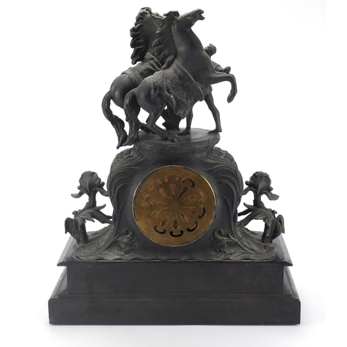 2408 - Patinated Spelter black slate and marble mantel clock with marley horses and trainer, striking on a ... 